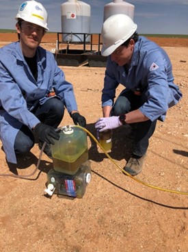 James Gardiner assists fellow NETL researcher Daniel Lipus with sampling another produced water well 