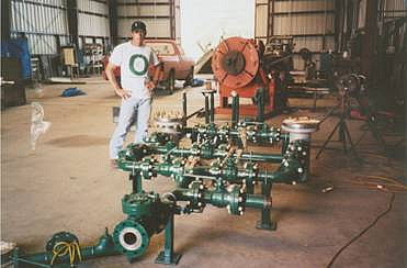 Custom-designed and fabricated modular water filtration plumbing for easy transportation and setup being tested at independent fabrication shop, Clute, TX. Note stainless steel basket strainers are also custom-designed and assembled by fabricator. Jeff Ahern (shown) and Cary Brock were the designers.