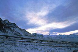 The Trans-Alaska Pipeline is shown against the backdrop of the Brooks Range foothills.