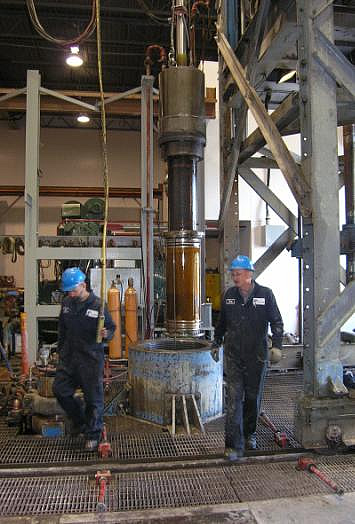 Removing drilled sample from pressure vessel.