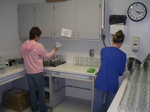 Technicians measuring fluid samples for life-cycle analysis at the Acculab analytical laboratory. Photo by John Veil.