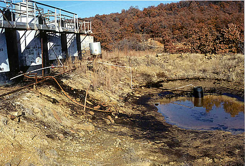 A tank battery showing produced water discharged to a holding pond in Osage County, OK. The fate of trace hydrocarbons, which leak from such holding ponds, was the focus of the research.
