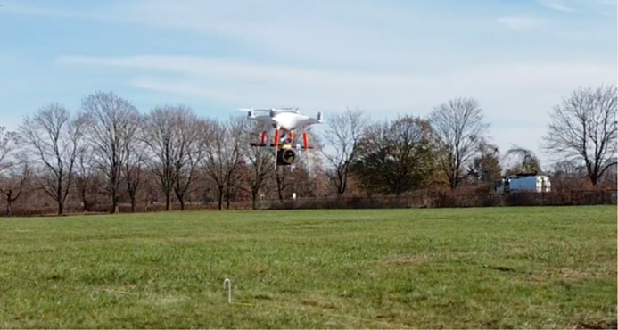 Mavic Phantom 4 with 2” reflector hanging below it. Note that additional "legs" for the drone had to be added to allow for take-off and landing with the retroreflector hanging below the body.