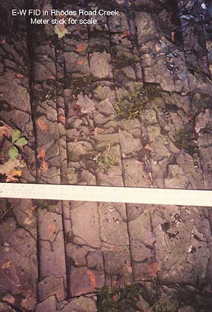 Surface Fracture Image: E-W FID in Rhodes Road Creek, Meter stick for scale.