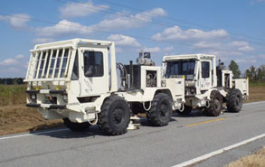 Vibroseis trucks being utilized for the acquisition of seismic data to characterize the subsurface at a CO2 storage site.