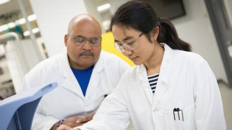 McMahan Gray, left, mentors Qiuming Wang last summer as they test sorbent structures in the NETL polymer synthesis lab.