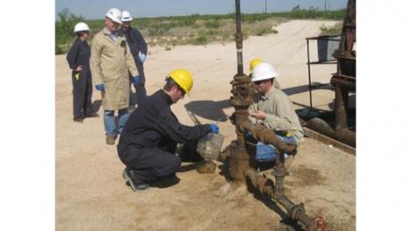 NETL researcher James Gardiner samples produced water at a CO2-EOR field in Texas 