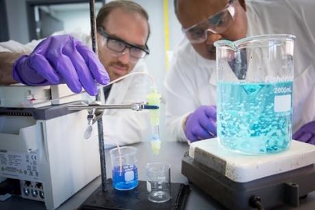 NETL’s Walter Wilfong, left and McMahan Gray, right, experiment with the BIAS technology.