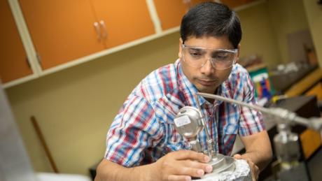 Researcher working on equipment