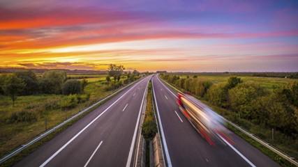 Log exposure photograph of a highway at sunset.