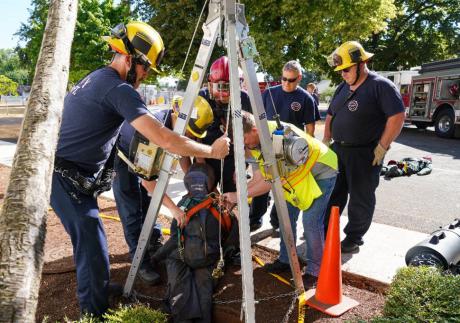 A tripod and winch being used to remove rescue dummies representing workers from a gas-filled confined space during a full-scale training exercise at NETL-Albany.