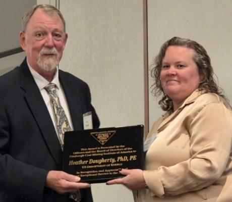Heather Dougherty receives the PCMIA Exceptional Service Award from Joseph Zelanko, PCMIA president.