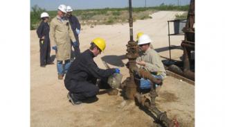 NETL researcher James Gardiner samples produced water at a CO2-EOR field in Texas 