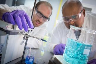 NETL researchers Chris Wilfong and Mac Gray (right) use BIAS sorbents to extract solubilized rare earth elements from aqueous solutions.