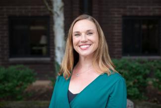 A photogarph of Christina Lopano, a Caucasian woman with blonde hair, blue eyes, and a teal long sleeve shirt on.