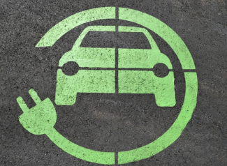 Electric Car Charging station symbol. An animated green car with another green power cord wrapping around it in a circle formation.
