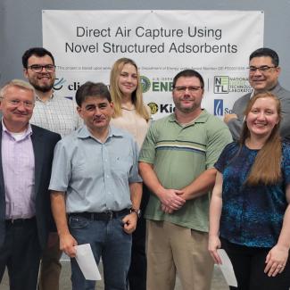 DOE and NETL representatives, from left, Andrew Hlasko, Zachary Roberts, Dan Hancu, Krista Hill, Andrew Jones, José Figueroa and Nicole Shamitko-Klingensmith visited Electricore in Fountain Valley, California, to discuss a project to capture CO2 from the air using a novel solid sorbent laminate filter technology. The group received a tour of the test plant and a project status update. 