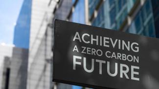 Building sign that reads "Achieving a zero carbon future."