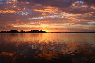 Large body of water at sunset.