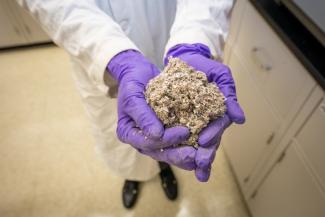 Compressed post-consumer plastic and biomass waste.