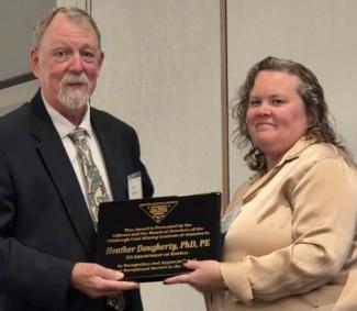 Heather Dougherty receives the PCMIA Exceptional Service Award from Joseph Zelanko, PCMIA president.